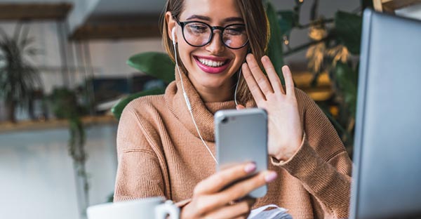 Lady waving to screen in live chat